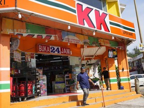 A customer walks out of a KK Mart convenience store