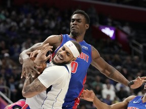 Dallas Mavericks center Daniel Gafford (21) is defended by Detroit Pistons center Jalen Duren during the second half of an NBA basketball game, Saturday, March 9, 2024, in Detroit.