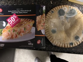 Box of frozen Pacific salmon pie with mouldy pie out of packaging.