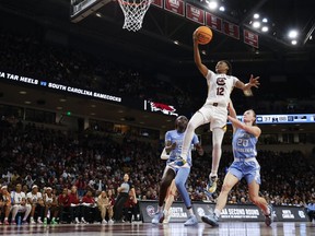 South Carolina guard MiLaysia Fulwiley (12) drives to the basket ahead of North Carolina forward Maria Gakdeng (5) and guard Lexi Donarski (20) during the second half of a second-round college basketball game in the women's NCAA Tournament in Columbia, S.C., Sunday, March 24, 2024.