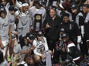 South Carolina celebrates with the regional championship trophy after defeating Oregon State in an Elite Eight round college basketball game during the NCAA Tournament, Sunday, March 31, 2024, in Albany, N.Y.