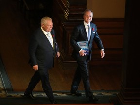 Peter Bethlenfalvy, Ontario's Minister of Finance, right, walks with Premier Doug Ford at Queen's Park in Toronto, Thursday, Nov. 2, 2023.