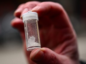 A Portland Police officer holds a vial of meth found after citing someone for drug use in downtown Portland, Ore., on Jan. 25, 2024.