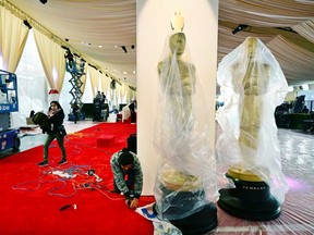 Oscars statues are placed in position as preparations continue on the red carpet on March 8, 2024, in Hollywood, Calif., for the 96th Academy Awards on March 10.