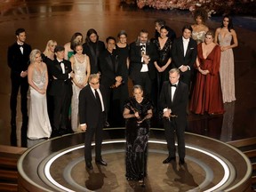 Left to right: Jack Quaid, Florence Pugh, Ellen Mirojnick, Cillian Murphy, Emily Blunt, Ludwig Goransson, Charles Roven, Robert Downey Jr., Luisa Abel, Emma Thomas, Hoyte van Hoytema, Ruth De Jong, Christopher Nolan, Josh Hartnett, Ashley Everett and Claire Kaufman accept the Best Picture award for "Oppenheimer" onstage during the 96th Annual Academy Awards at Dolby Theatre on March 10, 2024 in Hollywood, Calif.