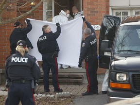 Coroners remove the bodies of six people, including four children, from a home at 324 Berrigan Drive in Barrhaven on Thursday, March 7, 2024.