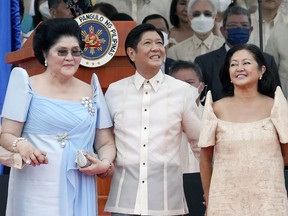 President Ferdinand Marcos Jr. stands with his mother Imelda Marcos, left, and his wife Maria Louise Marcos, right, during his inauguration ceremony to become the country's 17th president at the National Museum in Manila, Philippines, on June 30, 2022.