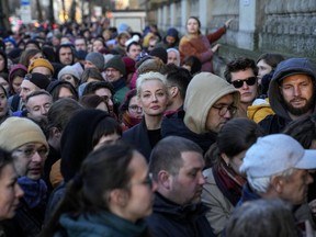 Yulia Navalnaya, center, widow of Alexey Navalny, stands in a queue with other voters at a polling station near the Russian embassy in Berlin, after noon Sunday, March 17, 2024. The Russian opposition has called on people to head to polling stations at noon on Sunday in protest as voting takes place on the last day of a presidential election that is all but certain to extend President Vladimir Putin's rule after he clamped down on dissent. AP can't confirm that all the voters seen at the polling station at noon were taking part in the opposition protest.