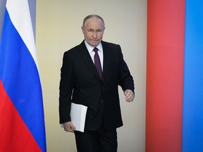 Russian President Vladimir Putin enters a hall to deliver his state-of-the-nation address in Moscow, Russia, Thursday, Feb. 29, 2024.