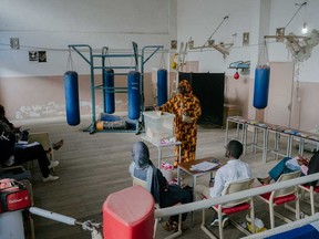 A voter casts her ballot last minute at a polling station in Iba Mar Diop Stadium, in the Medina neighbourood, Dakar, on March 24, 2024 during the Senegalese presidential elections.