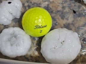 In this image provided by Randy Smith, large chunks of hail are compared to the size of a golf ball, Wednesday night, March 13, 2024, in Shawnee, Kan.