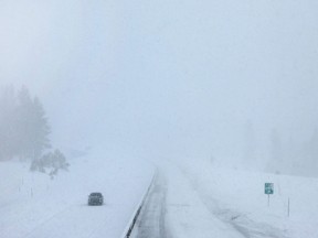 A vehicle makes its way on a section of Interstate 80 which remains closed due to snow during a powerful multiple day winter storm in the Sierra Nevada mountains on March 3, 2024 in Truckee, Calif.