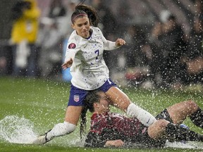 United States' Alex Morgan, above, collides with Canada's Vanessa Gilles during the first half of a CONCACAF Gold Cup women's soccer tournament semifinal match, Wednesday, March 6, 2024, in San Diego.