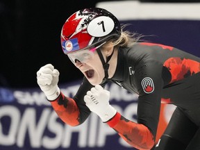 Canada's Kim Boutin celebrates winning the gold medal in the women's 500 meters final during the World Championships Short Track skating at Ahoy Arena in Rotterdam, Netherlands, Saturday, March 16, 2024.THE CANADIAN PRESS/AP/Peter Dejong