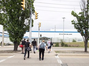 Workers arrive for their shift at the Chrysler (FCA) assembly Plant in Windsor, Ont., on Tuesday, June 12, 2018.&ampnbsp;Stellantis says its electric Dodge Charger will be built at the Windsor, Ont. assembly plant.