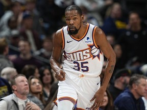Phoenix Suns forward Kevin Durant gestures after hitting a 3-point basket against the Denver Nuggets in overtime of an NBA basketball game Tuesday, March 5, 2024, in Denver.