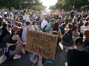 Demonstrators march and gather near the Texas Capitol following the U.S. Supreme Court's decision to overturn Roe v. Wade, June 24, 2022, in Austin, Texas.