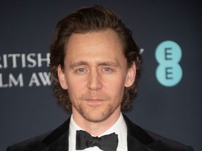 Tom Hiddleston poses at the EE British Academy Film Awards in London