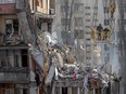 Rescuers clear debris from a multi-story building