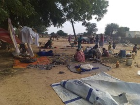 Residents displaced from a surge of violent attacks squat on blankets and in hastily made tents in the village of Masteri in west Darfur, Sudan, on July 30, 2020.