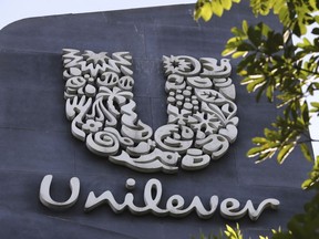 FILE - A Unilever logo is displayed outside the head office of PT Unilever Indonesia Tbk. in Tangerang, Indonesia, Tuesday, Nov. 16, 2021. Unilever, the company that makes Ben & Jerry's ice cream, Dove soaps and Vaseline, says it's cutting 7,500 jobs and spinning off its ice cream business to reduce costs and boost profits.