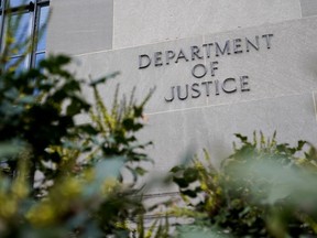 A sign marks an entrance to the Robert F. Kennedy Department of Justice Building