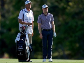 Justin Thomas and caddie, Jim "Bones" MacKay, look on during the second round of THE PLAYERS Championship.