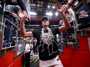 Zach Edey of the Purdue Boilermakers celebrates with fans after defeating the Tennessee Volunteers.