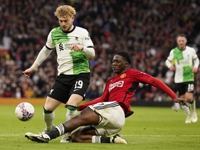 Liverpool's Harvey Elliott is tackled by Manchester United's Kobbie Mainoo during their FA Cup quarterfinal match.