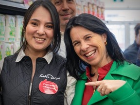 Mayor Valérie Plante points to a sticker on Sabor Latino supermarket manager Sandra Garcia’s uniform asking for patience while she takes French lessons earlier in April. “Although we want to be welcoming to everybody, we should be proud and we should encourage people to only say ‘Bonjour’” in store greetings, Plante said on Tuesday, April 23, 2024.