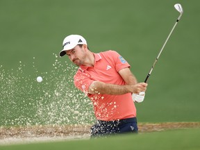 Nick Taylor plays a shot from a bunker on the second hole during a practice round prior to the 2024 Masters Tournament.