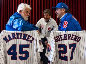 Gazette editorial cartoonist Terry Mosher, left, chats with Stephen Bronfman, centre, and Perry Giannias during the launch of Mosher's new book, Aislin’s Montreal Expos: A Cartoonist's Love Affair, at the Atwater Library in Montreal on Wednesday April 10, 2024.