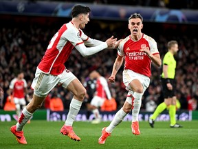 Leandro Trossard of Arsenal celebrates with teammate Kai Havertz after scoring his team's second goal during the UEFA Champions League.