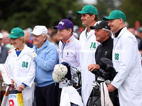 The Honorary Starters Tom Watson of The United States, Jack Nicklaus of The United States and Gary Player of South Africa pose with their caddies and Fred Ridley the Chairman of Augusta National Golf Club on the first tee.