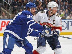 Aleksander Barkov of the Florida Panthers battles against Auston Matthews of the Toronto Maple Leafs.