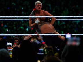 Cody Rhodes prepares to deliver a Cross Rhodes to Roman Reigns.
