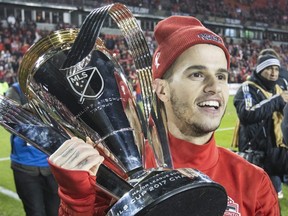 Toronto FC forward Sebastian Giovinco celebrates with the MLS Cup.
