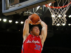 Blake Griffin of the Los Angeles Clippers elevates for the dunk against David Lee of the Golden State Warriors in 2010.