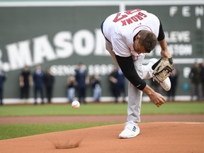 Rob Gronkowski, former NFL player for the New England Patriots spikes the ball on the mound for a ceremonial first pitch.