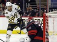 Boston Bruins' David Pastrnak slips the puck past Carolina Hurricanes goaltender Frederik Andersen.