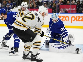 Toronto Maple Leafs goaltender Joseph Woll makes a save as Boston Bruins defenceman Kevin Shattenkirk looks for a rebound.