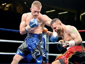 Brandon Cook connects with a left hook to the face of challenger Davide Doria during a WBA Inter-Continental Super Welterweight title fight.