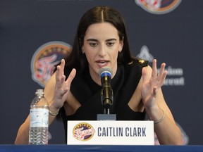 Indiana Fever's Caitlin Clark speaks during a news conference.