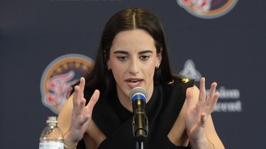 Indiana Fever's Caitlin Clark speaks during a news conference.