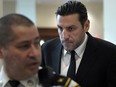 Boston Bruins forward Milan Lucic is flanked by court officers as he arrives at Boston Municipal Court on Nov. 21, 2023.