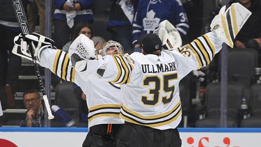 Jeremy Swayman and Linus Ullmark of the Boston Bruins celebrate a victory against of the Toronto Maple Leafs.