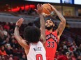 Gary Trent Jr. of the Toronto Raptors shoots over Coby White of the Chicago Bulls.