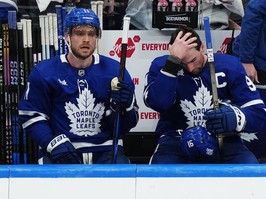 Toronto Maple Leafs' Max Domi, left, and John Tavares react on the bench during Game 4.
