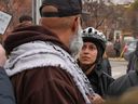 Toronto Police Const. Reem Raza stands her ground while being challenged by pro-Palestinian protesters on Saturday, March 30, 2024, in Toronto.