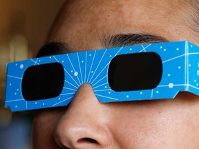 In this photo illustration, a woman models eclipse glasses from Warby Parker on April 01, 2024 in New York City.